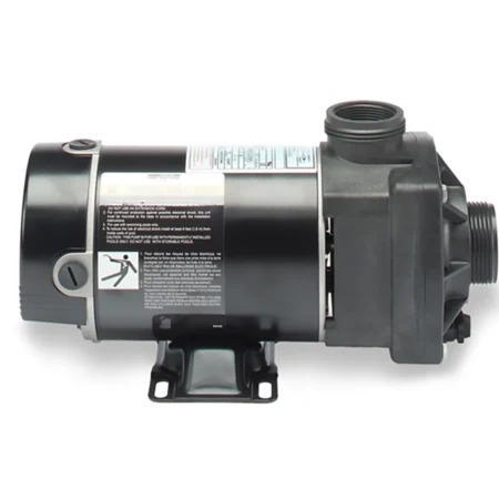 Alternate side view of the Carvin Stingray above-ground pool pump showing the motor housing, threaded inlet and outlet ports, safety labels, rear-mounted power switch, and mounting base